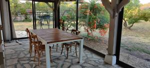 a wooden table and chairs on a patio at Maison au bord de dune et océan in Labenne