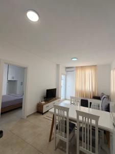 a living room with a table and chairs and a bedroom at DS apartments in Golem