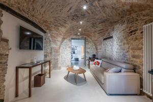 a living room with a couch and a table at Borgo Baccile by Vini Fantini in Crecchio