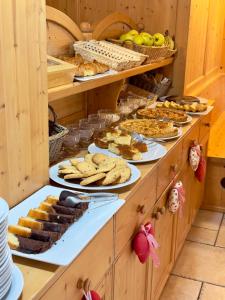 a buffet with many different types of food on plates at Agritur Casamela in Taio