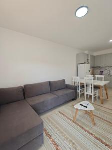 a living room with a couch and a table at DS apartments in Golem +24 photos