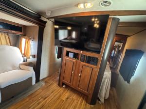 a living room with a large tv in a rv at Florida VIBE in Homosassa Springs