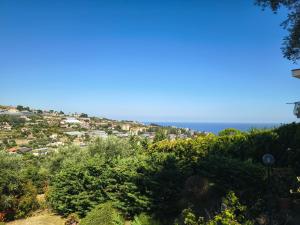 a town on a hill with the ocean in the background at Sunset Garden Sanremo in Sanremo