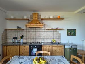 a kitchen with a table with bananas on it at Sunset Garden Sanremo in Sanremo +6 photos