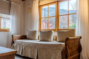 a bed in a room with a large window at Apart Hotel Agua Escondida in San Martín de los Andes
