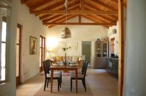 a kitchen and dining room with a table and chairs at The Art House in Kotrónion +18 photos