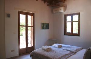 a bedroom with a bed with towels on it at The Art House in Kotrónion