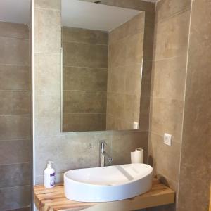 a bathroom with a white sink and a mirror at Tara Rafting Resort in Foča +55 photos