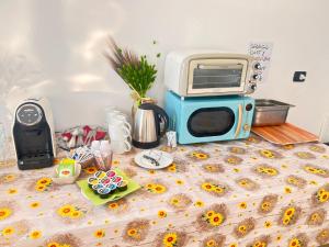 a table with a toaster on top of a bed at Ostello Brebei Niedda - Base Camp Outdoor & View in Gonnesa