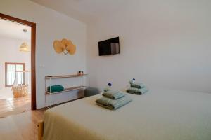 a bedroom with a bed with two pillows on it at B&B Casa Mijo in Daimalos