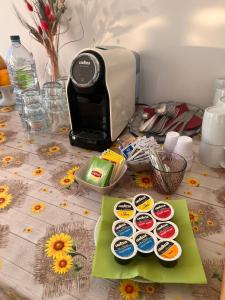 a table topped with a toaster and plates of food at Ostello Brebei Niedda - Base Camp Outdoor & View in Gonnesa