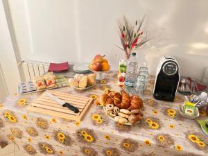 a table with bread and other food on it at Ostello Brebei Niedda - Base Camp Outdoor & View in Gonnesa