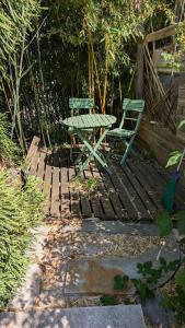 a picnic table and a chair on a wooden deck at HOME HOSE in Monistrol-sur-Loire