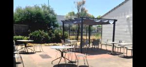 a group of tables and chairs in a patio at Studio Luna Rose in Merville
