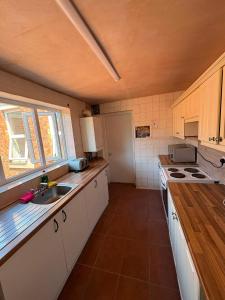 a kitchen with a sink and a counter top at Goody Suites in Newcastle upon Tyne