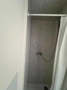 a shower with a shower curtain in a bathroom at Goody Suites in Newcastle upon Tyne