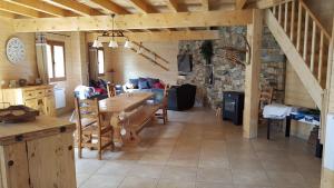 a living room with a table and a stone wall at Can PUGAT in Bolquere Pyrenees 2000 +10 photos