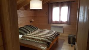 a bedroom with a bed in a room with a window at Can PUGAT in Bolquere Pyrenees 2000