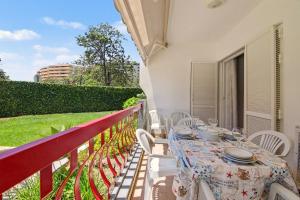 a table with white chairs on a balcony at T2 Tivoli in Vilamoura
