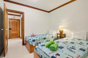 a bedroom with two beds with green towels on it at T2 Tivoli in Vilamoura +18 photos