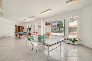 a living room with a glass table and a pool at T2 Tivoli in Vilamoura