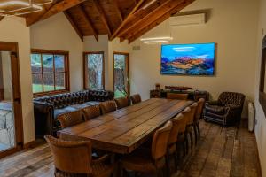a conference room with a wooden table and chairs at Apart Hotel Agua Escondida in San Martín de los Andes