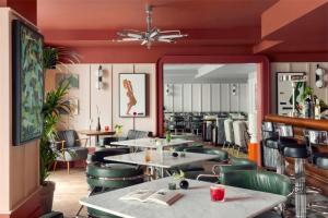 a restaurant with tables and chairs and a mirror at Schwan Locke in Munich +20 photos