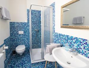a bathroom with a sink and a shower at Die kleine Pension in Delmenhorst +35 photos