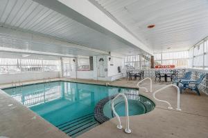 a large swimming pool in a building at Surfside - Boutique Studio Condo with Pool in Hampton +33 photos
