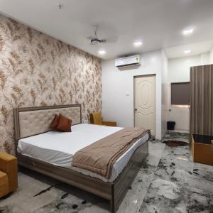 a bedroom with a bed and a flat screen tv at Yash Residency Lodging And Boarding in Ulhāsnagar