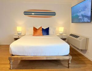 a bedroom with a large bed with two night stands at Surfside - Boutique Studio Condo with Pool in Hampton