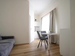 a bedroom with a bed and a table and a window at Die kleine Pension in Delmenhorst