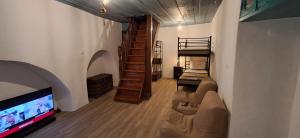 a living room with a couch and a flat screen tv at Kissamitakis Guesthouse in Monemvasia
