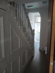 a hallway with a white door and a stairway at AAA lodge in Middlesbrough