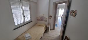 a small bedroom with a bed and a window at GUEST HOME in Casamicciola Terme