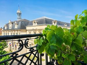 a building with a clock tower on top of it at Le cœur de Troyes - Appartement & Studio in Troyes