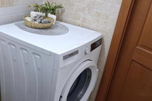 a white washing machine with a basket on top of it at Apulia lux in Taranto