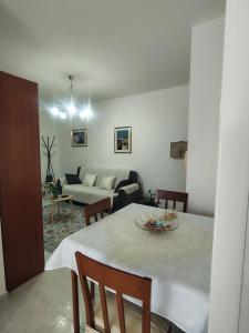 a living room with a table and a couch at "Da Carla e Sandro"- Appartamento con parcheggio privato in Quartucciu