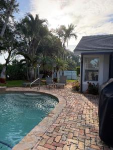 a backyard with a swimming pool and a house at Regiane Residence in Wellington