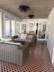 a screened in porch with a couch and a table at Regiane Residence in Wellington +37 photos