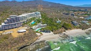 an aerial view of a resort on a beach at Beachfront Modern Sanctuary - Bolongo in Higuera Blanca