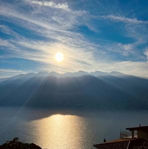 a view of a lake with the sun in the sky at Casa Cristina - Vista Lago in Tignale
