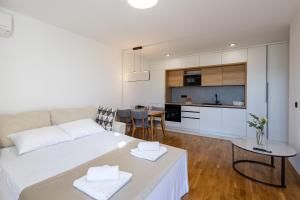 a living room with a bed and a kitchen at Villa Sunset Mostar in Mostar