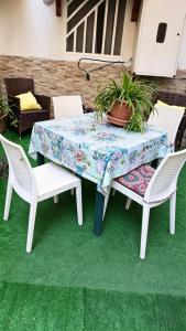 a table with two chairs and a plant on it at Apulia lux in Taranto