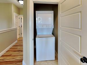 a washer and dryer in a hallway with a door at Baja Breeze in Port Aransas