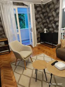 a living room with a chair and a couch at Ksandra in Topla
