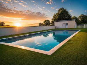 a swimming pool in the yard of a house at Le Chalet Bellevue, Vue Panoramique, Piscine et Clim in Ayen