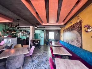 a restaurant with wooden tables and chairs and a bar at Apartmani San Snova in Kotor-Varoš