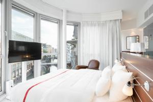 ein Schlafzimmer mit einem großen Bett und einem großen Fenster in der Unterkunft Ruby Lotti Hotel Hamburg by IHG in Hamburg