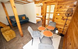 a living room with a table and chairs and a couch at Tara Rafting Resort in Foča